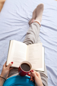 Woman reading a book in bed